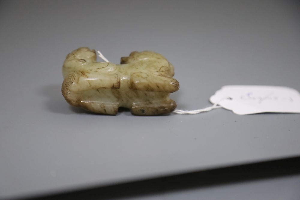 A Chinese pale celadon and brown jade group of a lion dog and cub, 18th / 19th century, L.6.3cm